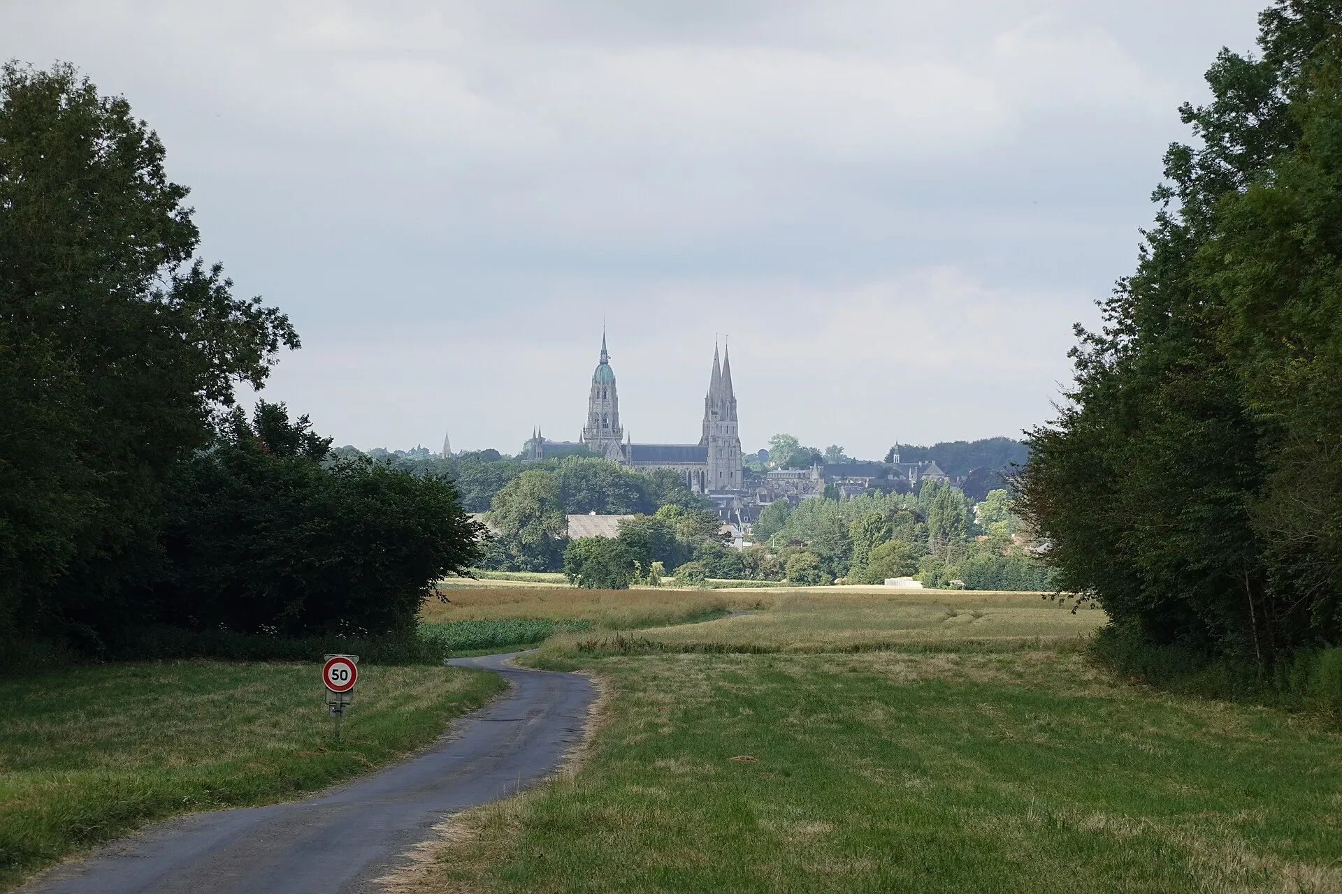 Bayeux cathedral rising above the town, seen from the surrounding countryside